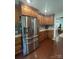 Well-lit kitchen featuring wood cabinets, stainless steel appliances, granite countertops, and hardwood floors at 517 Grassy Creek Run, Chester, SC 29706