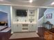 Open-concept living room features custom built-in shelving and a decorative cabinet with great natural light at 517 Grassy Creek Run, Chester, SC 29706
