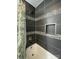 Modern tiled shower featuring decorative accent stripes and a built-in niche at 517 Grassy Creek Run, Chester, SC 29706