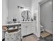 Light and airy bathroom showcasing a vanity, round mirror, and sleek black fixtures at 5262 Mckenzie Trl, Conover, NC 28613