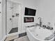 Modern bathroom with a sleek soaker tub, walk-in shower, and black hexagon tile at 5262 Mckenzie Trl, Conover, NC 28613