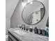 Modern bathroom with stylish vanity, granite countertop, dark wood cabinetry, and a sleek round mirror at 5262 Mckenzie Trl, Conover, NC 28613