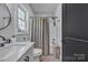 Bright bathroom featuring a modern vanity, a shower, and a window at 5262 Mckenzie Trl, Conover, NC 28613