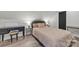 Cozy bedroom featuring light wood floors, a comfortable bed, and a stylish accent desk at 5262 Mckenzie Trl, Conover, NC 28613