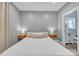 A cozy bedroom showcasing bedside tables and lamps with a full bath across the hall at 5262 Mckenzie Trl, Conover, NC 28613