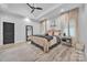 A beautifully staged main bedroom featuring a neutral palette, tray ceilings, and wood flooring at 5262 Mckenzie Trl, Conover, NC 28613