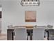Formal dining area with modern light fixture, dark-wood table, and upholstered gray chairs at 5262 Mckenzie Trl, Conover, NC 28613