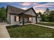 Inviting front porch with landscaping and outdoor seating, a perfect spot to relax and enjoy the outdoors at 5262 Mckenzie Trl, Conover, NC 28613
