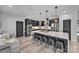 Modern kitchen with a breakfast bar, sleek black cabinets, and stainless steel appliances at 5262 Mckenzie Trl, Conover, NC 28613