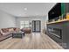 Bright and airy living room with hardwood floors, a black fireplace, and comfortable seating at 5262 Mckenzie Trl, Conover, NC 28613