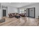 Open-concept living area with new floors, comfortable furnishings, and modern finishes with access to the foyer at 5262 Mckenzie Trl, Conover, NC 28613