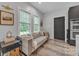 Comfortable living room featuring a sofa, natural light from the windows and hardwood flooring at 5262 Mckenzie Trl, Conover, NC 28613