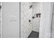 Bright shower with hexagon tiles, chrome fixtures, and a clear glass door at 5262 Mckenzie Trl, Conover, NC 28613