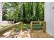 A new wooden back porch features modern cable railings and a backyard view at 5444 Datha Ave, Charlotte, NC 28269