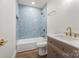 Updated bathroom features tile surround over the tub and modern vanity at 5444 Datha Ave, Charlotte, NC 28269