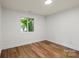 Bedroom with wood-look flooring, neutral paint and bright, natural light at 5444 Datha Ave, Charlotte, NC 28269