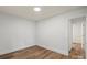 A bright bedroom features luxury vinyl plank flooring and crisp white walls at 5444 Datha Ave, Charlotte, NC 28269