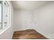 A well lit bedroom features luxury vinyl plank flooring and crisp white walls at 5444 Datha Ave, Charlotte, NC 28269