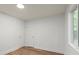 A bright bedroom features luxury vinyl plank flooring and two closets at 5444 Datha Ave, Charlotte, NC 28269
