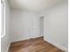 A bright bedroom features luxury vinyl plank flooring and crisp white walls at 5444 Datha Ave, Charlotte, NC 28269