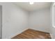A bright bedroom features luxury vinyl plank flooring and white walls at 5444 Datha Ave, Charlotte, NC 28269