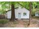 Charming home features a white exterior, black trim, and mature trees at 5444 Datha Ave, Charlotte, NC 28269