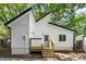An exterior view showcases the home's unique roofline and updated porch at 5444 Datha Ave, Charlotte, NC 28269