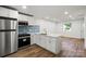 Modern kitchen with stainless steel appliances, white cabinets, and quartz countertops at 5444 Datha Ave, Charlotte, NC 28269