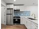 Updated kitchen features stainless steel appliances, white cabinets, and modern finishes at 5444 Datha Ave, Charlotte, NC 28269