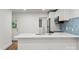 Bright modern kitchen with stainless appliances and white cabinets and a breakfast bar at 5444 Datha Ave, Charlotte, NC 28269