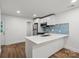 Bright kitchen features stainless appliances and white cabinets and a breakfast bar at 5444 Datha Ave, Charlotte, NC 28269