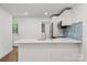Bright kitchen with stainless appliances, modern fixtures and a breakfast bar at 5444 Datha Ave, Charlotte, NC 28269