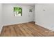 Living room with hardwood floors and bright light from the front door window at 5444 Datha Ave, Charlotte, NC 28269