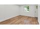 Living room with hardwood floors, white trim, and a view of the outdoors at 5444 Datha Ave, Charlotte, NC 28269