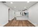 Bright open-concept living space features hardwood floors and white walls at 5444 Datha Ave, Charlotte, NC 28269