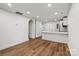 Bright open-concept living space features hardwood floors and white walls at 5444 Datha Ave, Charlotte, NC 28269