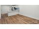 Bright open-concept living space features hardwood floors and white walls at 5444 Datha Ave, Charlotte, NC 28269