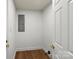 Utility room with white walls and wood look flooring and neutral colors at 5444 Datha Ave, Charlotte, NC 28269
