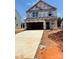 New construction home featuring an open garage and concrete driveway ready for personalization at 5606 Skinny Dr, Charlotte, NC 28215
