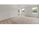 Spacious main bedroom featuring natural light, neutral paint, and plush carpeting at 5606 Skinny Dr, Charlotte, NC 28215