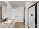 Bright bathroom featuring a granite countertop vanity and a walk-in shower with a black frame at 5607 Skinny Dr, Charlotte, NC 28215