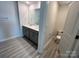Bathroom with dual sink vanity, gray cabinetry, wood look flooring, and a separate toilet room at 578 Sparkleberry St, Chester, SC 29706