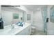 Bright bathroom featuring a double vanity, large mirror, and shower-tub combo at 578 Sparkleberry St, Chester, SC 29706