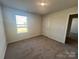 Bedroom featuring neutral walls, brown carpet, and a bright window allowing natural light to fill the room at 578 Sparkleberry St, Chester, SC 29706