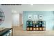 Open bonus room with teal accent wall, neutral carpet, and decorative shelving at 578 Sparkleberry St, Chester, SC 29706