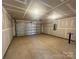 Garage with metal door, concrete floor and unfinished drywall at 578 Sparkleberry St, Chester, SC 29706
