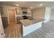 Kitchen with stainless steel appliances, granite countertops, gray cabinetry, and an island sink at 578 Sparkleberry St, Chester, SC 29706
