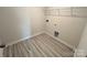 Laundry room featuring wood-look flooring, white walls and wire shelving at 578 Sparkleberry St, Chester, SC 29706