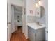 Well-lit bathroom featuring a modern vanity, round mirror, and mosaic tile backsplash at 6001 Charing Pl, Charlotte, NC 28211