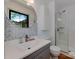 Updated bathroom with a glass shower, modern vanity, stylish mirror and flooring at 6001 Charing Pl, Charlotte, NC 28211